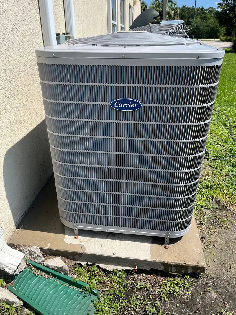 Carrier condenser on a pad beside a Florida home
