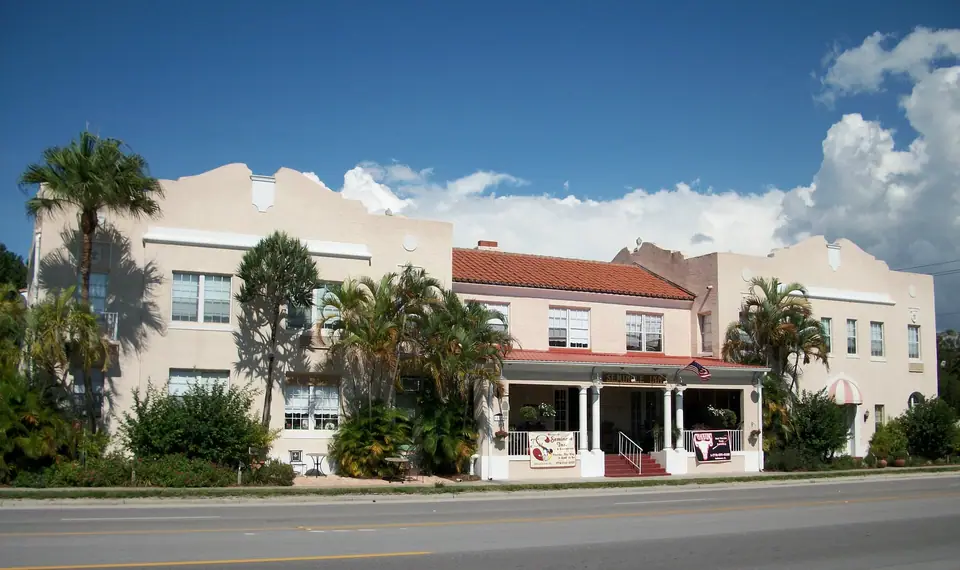 The historic Seminole Inn on a palm-lined street in Indiantown, FL